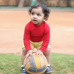 An outdoor session at the playground is a perfect way to capture a child's natural energy. This little one was completely absorbed with his ball, creating a perfect candid moment.