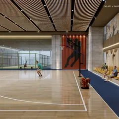 A wider view of the sports club, showing the basketball court alongside a paddle tennis court. These facilities are part of a comprehensive offering designed to elevate the standard of sports and recreation for residents.