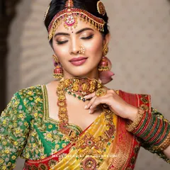 A complete South Indian bridal look, featuring a flawless, glowing base and soft glam eye makeup that complements the traditional gold jewelry and vibrant silk saree. This is a perfect example of the radiant and long-lasting bridal makeup I love to create.