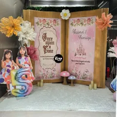 Once upon a time... a beautiful storybook backdrop for twin princesses, featuring their names and a fairy tale castle. The life-size cutout of the girls adds a lovely personal touch.