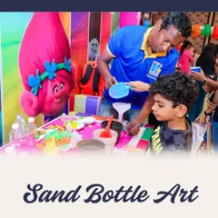 Creating colorful layers in a sand bottle art activity. With help from my staff, kids can make beautiful, decorative sand bottles to keep.