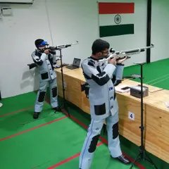 Two of our rifle athletes honing their skills side-by-side. We foster a supportive yet competitive environment for growth.