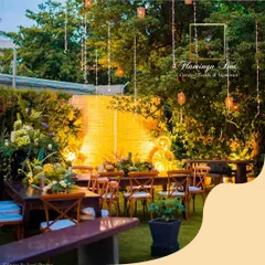 The backyard setting at night, transformed into a magical dining space. The warm light from the bamboo backdrop and hanging fairy lights created a cozy and inviting atmosphere.