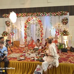 A religious ceremony (puja) taking place on a stage I decorated. The setup is both beautiful for the event and functional for the rituals.