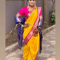 The vibrant yellow and pink of this Brahmani Navari drape captures the joyful spirit of a Maharashtrian wedding. I focus on achieving the perfect fit and fall, complete with traditional accessories like the nath and mundavalya, to create an authentic bridal look.