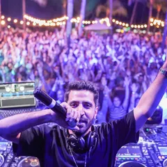 On the mic, in the moment, with the incredible crowd in Mauritius. Hyping the audience and connecting directly with them is a huge part of my live DJ sets. It's all about creating that shared, electric atmosphere.