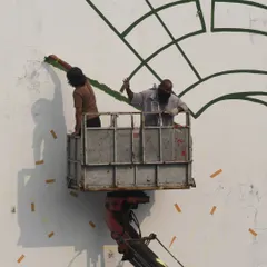 My crew and I working on the large-scale horse mural. Every big project is a collaboration, and working on a lift is part of the job when you're painting on the side of a building.