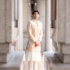 This is a perfect example of modern Indian groomswear. We chose a sophisticated embroidered sherwani in a neutral tone over a simple white kurta for the brother of the bride, creating a look that is both stylish and appropriate for the occasion.
