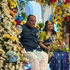 This mom-to-be chose a vibrant floral set with pops of orange and green to match her beautiful blue and green saree for her baby shower celebration.