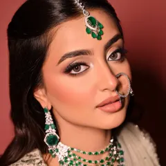 This portrait captures the complete regal essence of the look, with the intricate nath (nose ring) and maang tikka complementing the dramatic eye makeup.