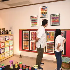 A father and daughter admiring the vibrant artwork on display. Moments like these, where art connects families, are what I cherish most.