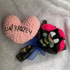 This was a very special custom order. It includes a small character bouquet and a soft, crocheted pink heart embroidered with the date "24/3/2024" to mark a special occasion.