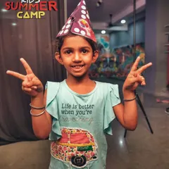 A happy camper showing off her victory signs. We focus on creating a positive and encouraging atmosphere where kids feel comfortable and happy.
