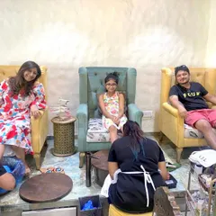Our salon setup allows friends and family to get pampered together. These clients are enjoying pedicures side-by-side in our comfortable, high-backed chairs.