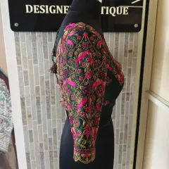 An emerald green blouse brought to life with dense floral and bird motifs in pink and gold thread. This piece showcases my love for vibrant, nature-inspired aari embroidery.