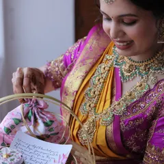 The beautiful mother-to-be admiring her custom return gift basket. This image captures the joy and gratitude shared during traditional ceremonies.