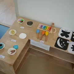 One of our learning zones, set up with sensory materials, musical instruments, and high-contrast cards for our youngest learners.
