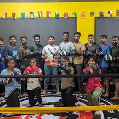 A great shot of our diverse group of fighters, men and women, standing together in the ring. This is our tribe.