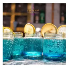For larger gatherings, I prepare batches of my signature mocktails to ensure consistent quality and quick service. These blue mocktails, served in popular mason jars with lemon wheel garnishes, are a crowd-pleaser and add a splash of color to any event bar.