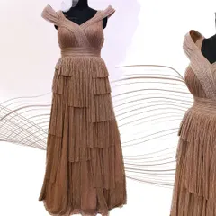 A studio shot of the shimmered rose gold gown, showing the intricate pleating and tiered skirt design.