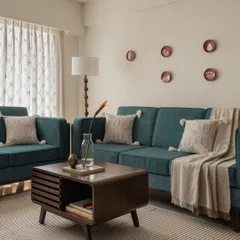 This living room combines comfort and style with a plush teal sofa set against a neutral wall. The mid-century modern coffee table and floor lamp add a touch of timeless elegance.