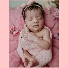 This is an example of a themed newborn portrait session. For this baby girl's photoshoot, I used a soft pink color palette, a gentle swaddle, and delicate butterfly props to create a sweet and dreamy image.