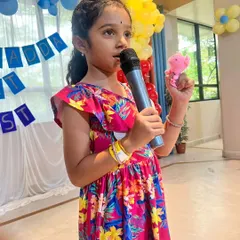 Confidence blooms on stage. Here, a young participant shares her story during our Kydzadda Lit Fest, an event designed to foster a love for reading and public speaking in a supportive environment.