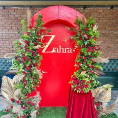 We designed this bold and beautiful bridal shower with a striking red backdrop and lush floral arches. The personalized name signage and touches of pampas grass added a modern yet glamorous feel to the event.