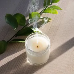 My candles are made to be enjoyed from start to finish. Here, a recently extinguished soy wax candle in a textured glass jar sends up a gentle wisp of smoke, showing the clean burn you can expect from my handmade products.
