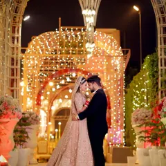 Your reception is a grand celebration, and your photographs should reflect that. I specialize in capturing the scale and beauty of your venue, like this stunning shot of Tanu and Kunal, creating an image that feels both epic and personal.