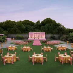 A wider view of the pastel pink and gold lawn wedding. I designed the layout to ensure every guest has a great view of the stage, creating a cohesive and elegant atmosphere for a large gathering.