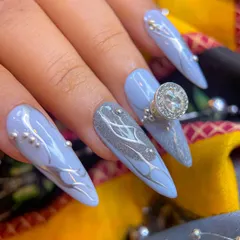 Another angle of the elegant grey Navratri nails, showing the long stiletto shape and the placement of silver beads and a large solitaire charm.