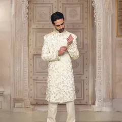 A timeless choice for any wedding. This off-white embroidered sherwani is the epitome of grace and sophistication, perfect for a groom or a close family member.