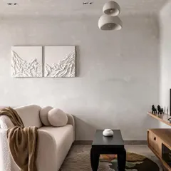 For this 450-square-foot apartment, I used the principles of wabi-sabi to create a soothing sanctuary. The living area features a curved boucle couch, textured art, and a neutral palette to create a calm backdrop, proving that even small spaces can feel expansive and peaceful.