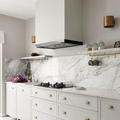 The beautiful kitchen from the Madras Home is luxe yet perfectly poised for everyday use. We used classic white shaker cabinets, a full-height marble backsplash, and brass hardware to create a timeless and elegant space.