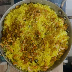 Our fragrant Lemon Rice, tempered with mustard seeds, curry leaves, and garnished with cashews and raisins for a delightful crunch.