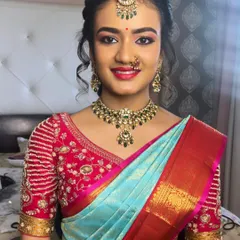 A classic South Indian traditional makeup look for a family wedding. I paired a warm, shimmering eye with a complementary pink lip shade to perfectly match her beautiful silk saree and temple jewelry.