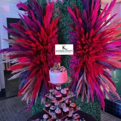 Creating fun photo spots is one of my favorite things to do. For this party, I designed a backdrop with a "Let's Party" neon sign and dramatic pampas grass wings against a lush green wall, perfect for birthday or anniversary photos.