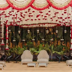 This traditional South Indian wedding stage at The Grand Castle features intricate floral work with red and white tuberose, creating a divine and elegant atmosphere for the ceremony.
