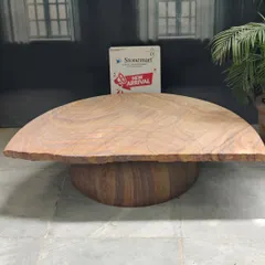 This modern stone seating bench features a smooth, curved top and a solid, rounded base. It's a contemporary design that works equally well in a luxury interior or an extraordinary backyard garden.