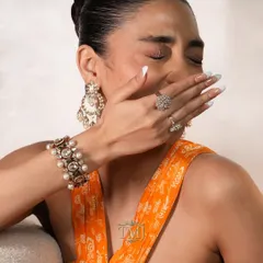 This stunning polki and pearl bracelet doubles up as a choker, shown here styled with matching pearl chandbalis and diamond rings for a complete, versatile look.
