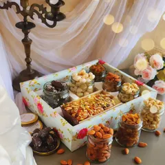 Our Lavish Tea Time Hamper is designed to impress. It features a beautiful floral tray filled with our signature Parsi Mawa Tea Cake, assorted premium nuts like cashews and almonds, and rich chocolate treats, making it a perfect gift for valued clients and partners.
