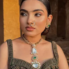 A profile view of the modern look, showcasing the clean lines of the makeup and the sleek, polished hairstyle.