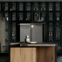 This design showcases luxury on a grand scale. A wall of sleek, illuminated glass cabinetry transforms storage into an art form, beautifully contrasted with the rich, wild oak nougat finish of the island.