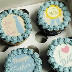 A sweet and simple way to celebrate Dad. This set of Father's Day cupcakes features light blue buttercream frosting and a variety of heartfelt messages and designs.
