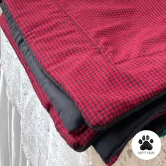 A stack of my cozy dog mats. This one features a classic red and black check pattern, perfect for adding a touch of warmth to your home.