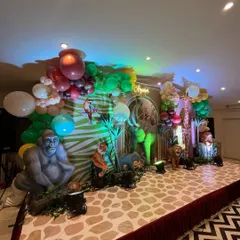 A side view of the grand jungle stage, showing the vibrant green and brown color palette and the variety of animal props used.