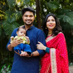 The first official family portrait. This photo was taken during a naming ceremony, capturing the proud parents with their newborn against a beautiful, natural backdrop.