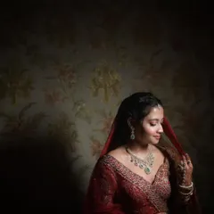 A moody and artistic bridal portrait. I used dramatic lighting here to sculpt the bride's features and create a sense of quiet contemplation, with the dark, patterned background adding to the atmosphere.