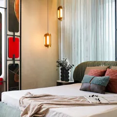 We envisioned this master bedroom as a sanctuary of comfort and character. A sage-green upholstered bed anchors the space, complemented by a sculptural, artistic headboard and warm ambient lighting, creating a room that feels both elegant and deeply personal.